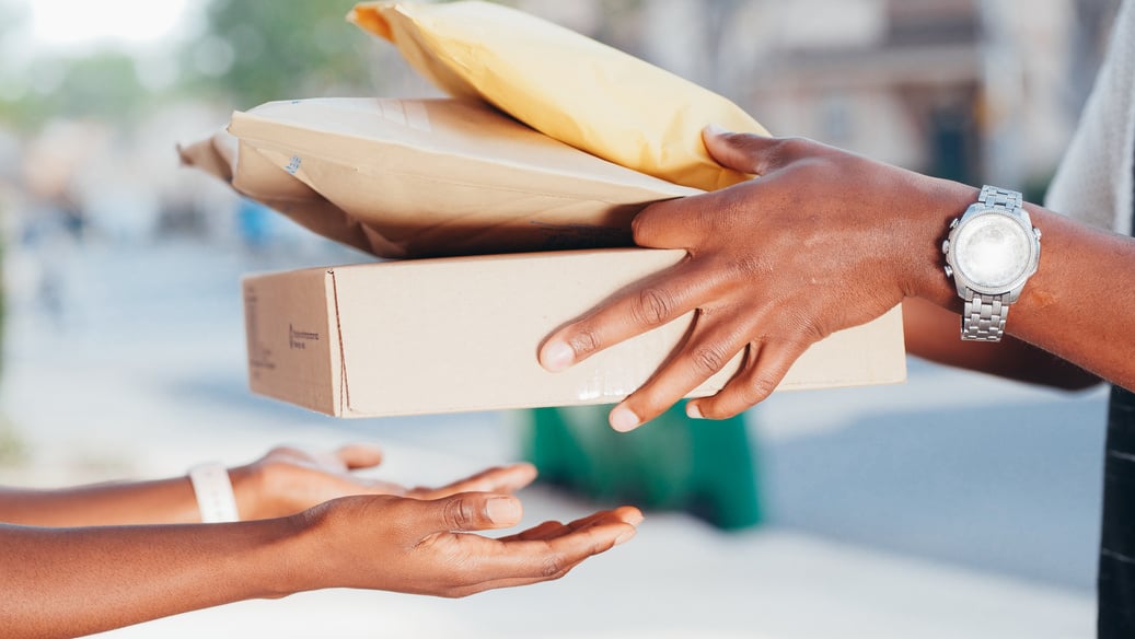 Hand Handing over Packages to Receiver 